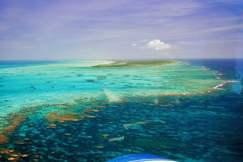 Horseshoe Reef from the air: coral heads and turquoise shallows running out from Anegada toward the horizon