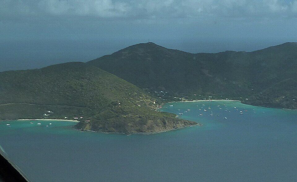 Jost Van Dyke from the air, from the south: White Bay on the left, Great Harbour and its moored boats on the right, the ridge between them (2012)