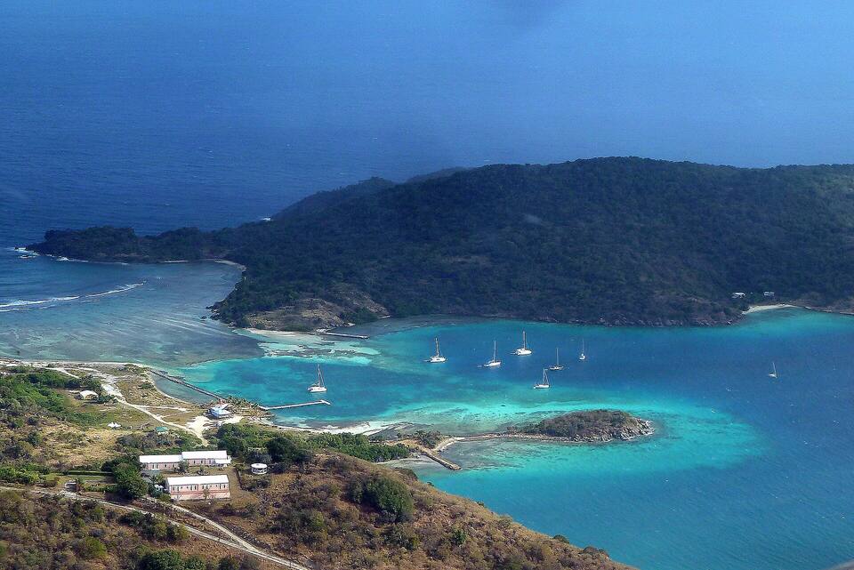 The east end of Jost Van Dyke from the air: Diamond Cay on its sandbar, boats in the sheltered water and Little Jost Van Dyke behind