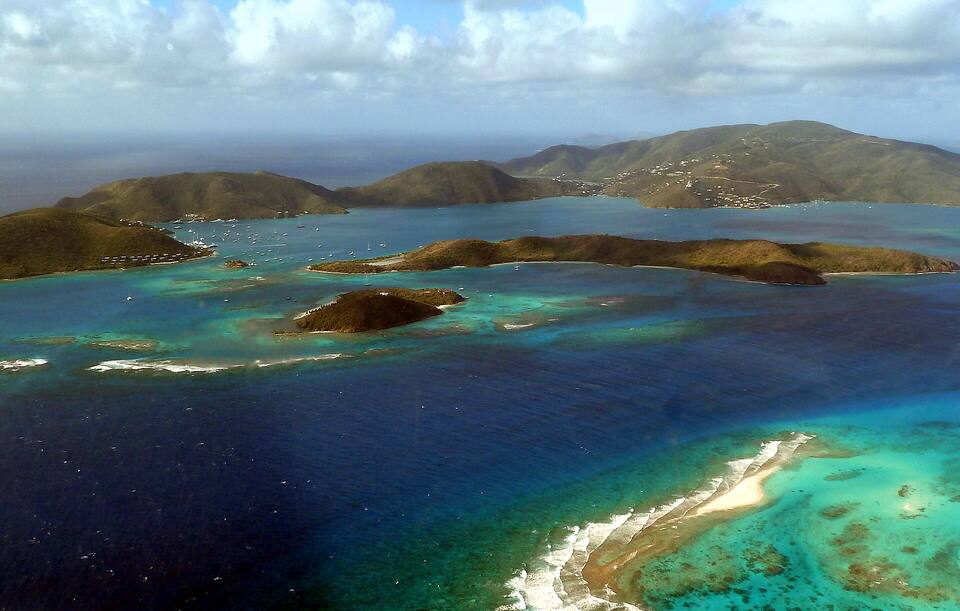 From the air north of the reef: Eustatia in the middle, Prickly Pear behind it and Virgin Gorda's hills round North Sound beyond
