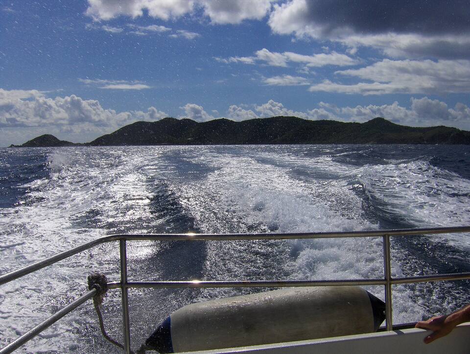 Looking back at Peter Island over the wake of the boat to Tortola