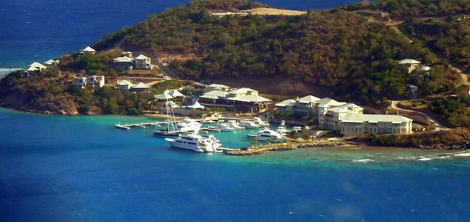 Scrub Island's marina and the resort buildings round it on Little Scrub, seen from a plane leaving Beef Island