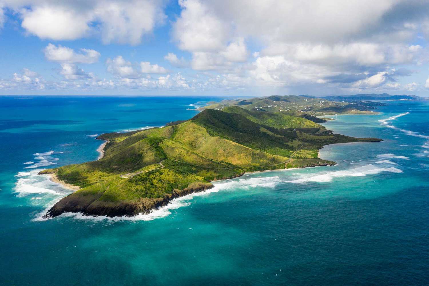 St. Croix's East End from the air: green hills and reef-ringed headlands at Point Udall, the north shore running west into the distance
