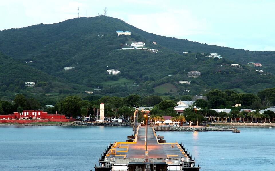 Frederiksted at dusk from the cruise pier: Fort Frederik and the waterfront under the west-end hills