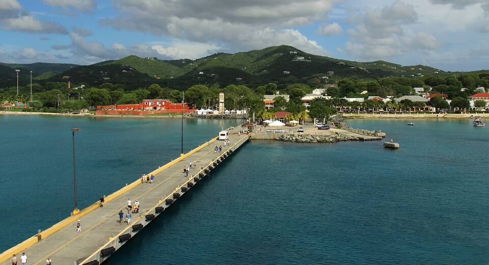The Frederiksted Pier from a ship's deck, running in to the town and the red walls of Fort Frederik