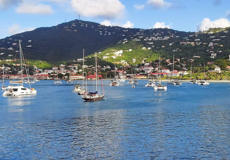 Charlotte Amalie from across the harbour: yachts at anchor, the town and the hills behind