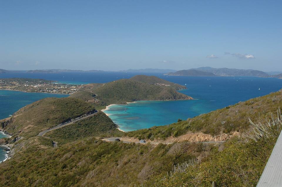 The view south-west from Gorda Peak: green ridges, turquoise bays and the island stretching away, Tortola on the horizon