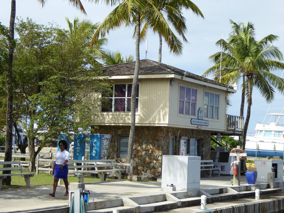A building at the Virgin Gorda Yacht Harbour in Spanish Town, under the palms beside the docks